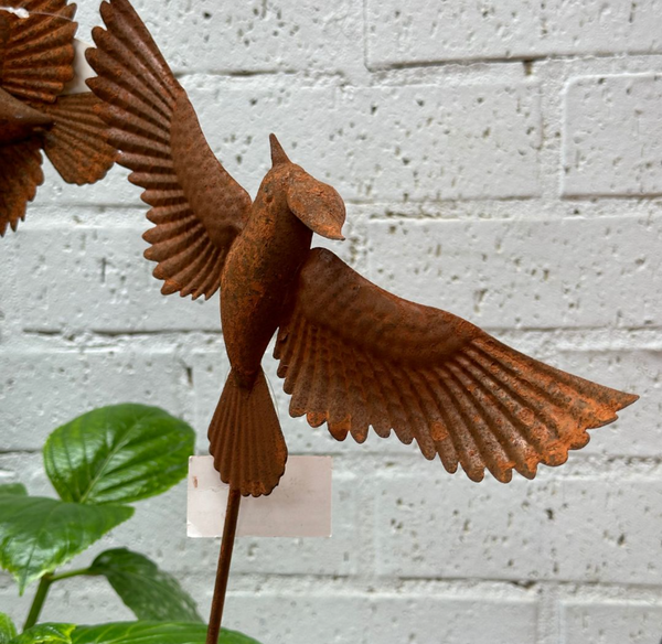 Rusted bird on stake