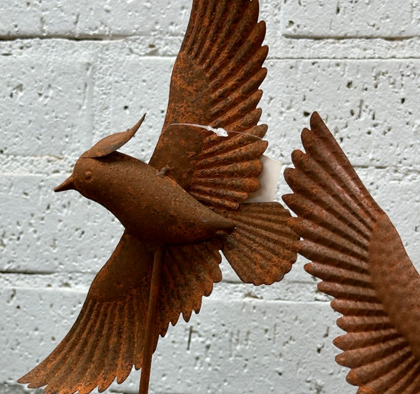 Rusted bird on stake