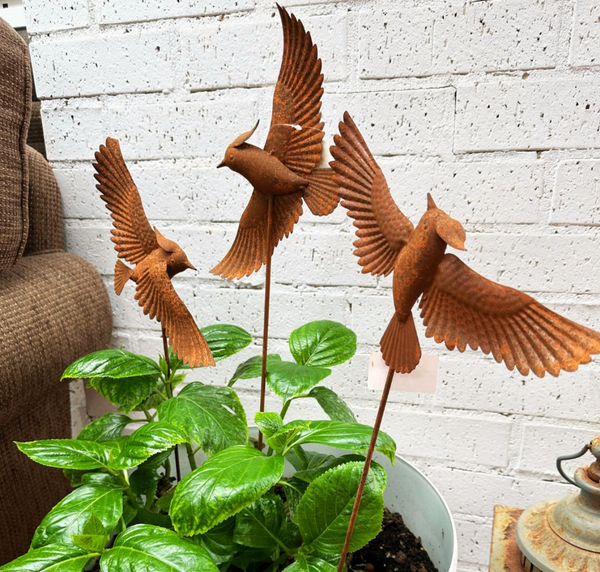 Rusted bird on stake