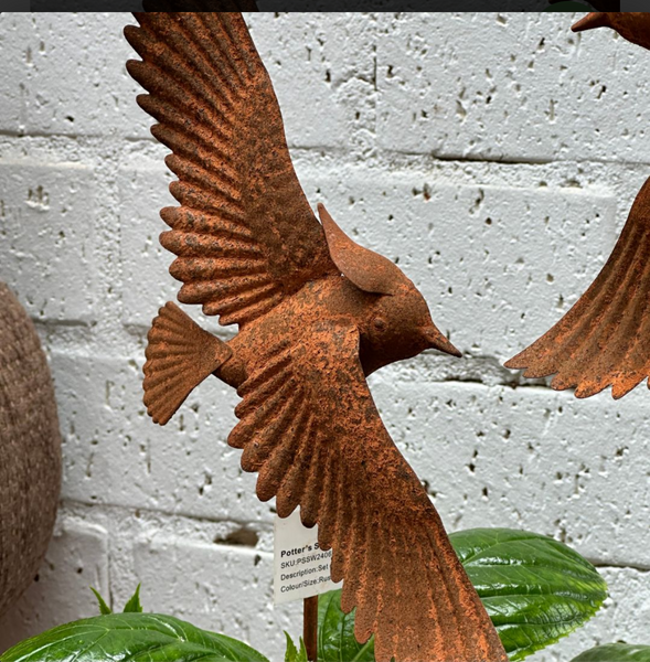 Rusted bird on stake